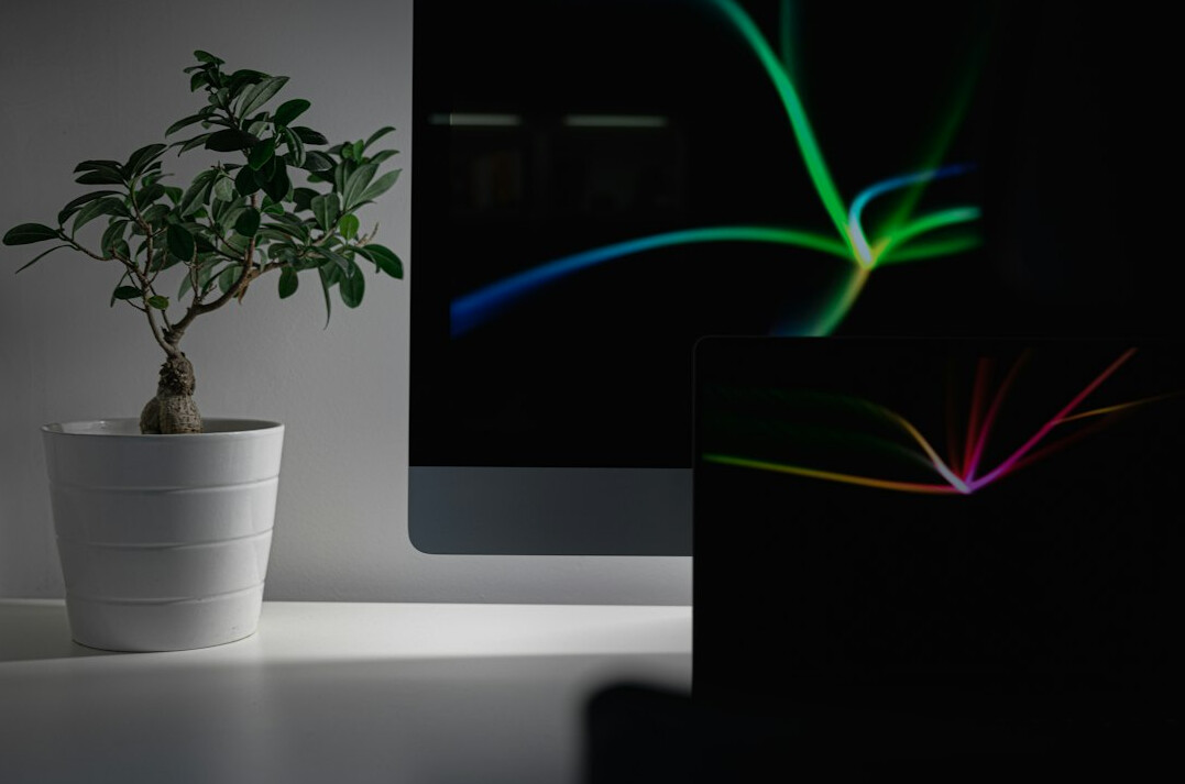 Monitor displaying colorful program code in a dark editor