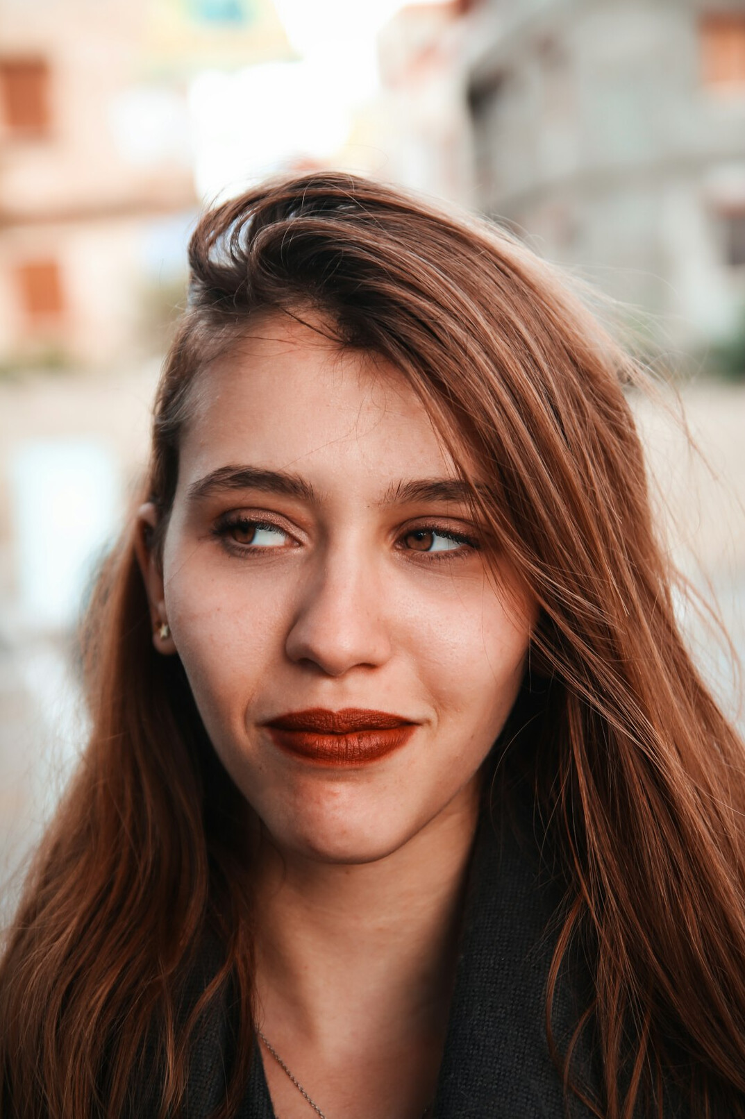 Portrait of a young woman with light brown hair smiling