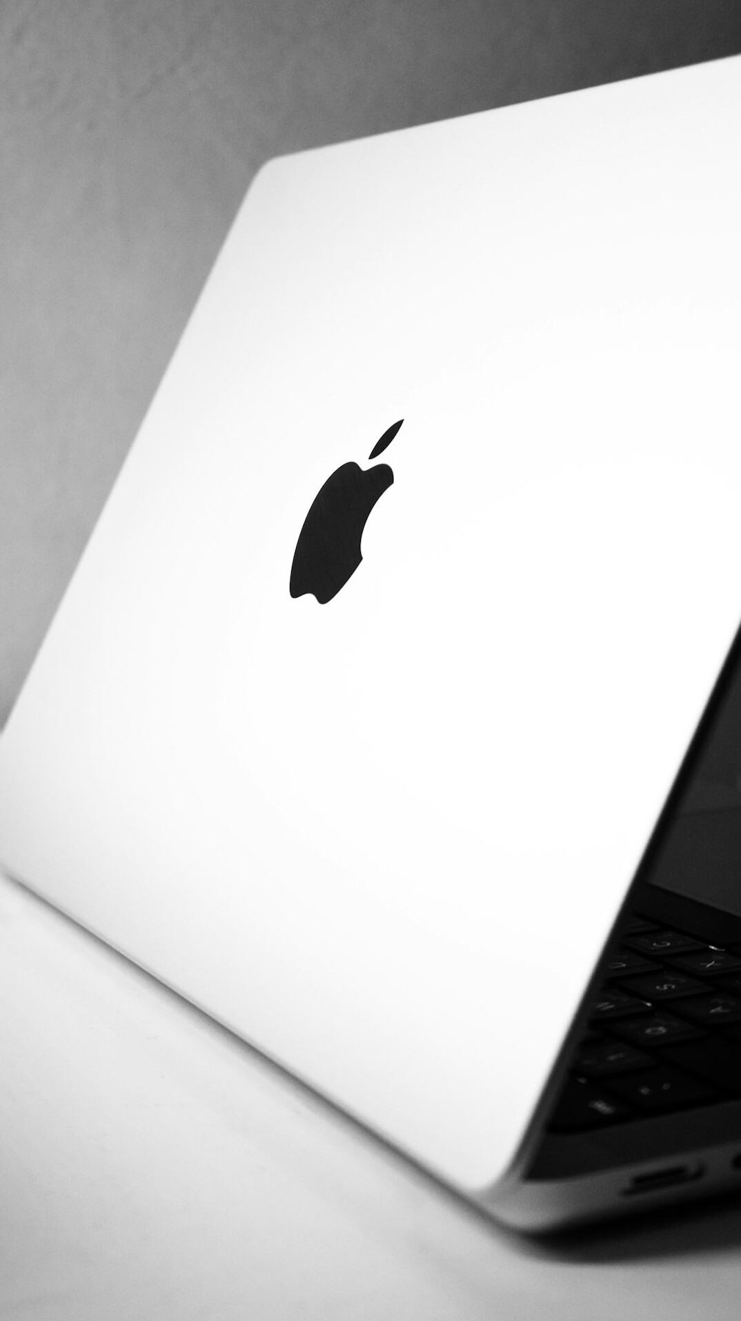 Laptop with code on screen next to a coffee cup on a desk